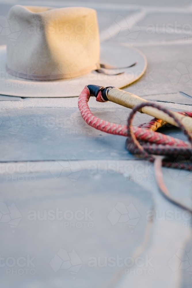 cowboy had and whip on paving - Australian Stock Image