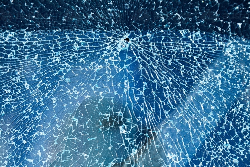 Cracks in glass of shattered car window - Australian Stock Image