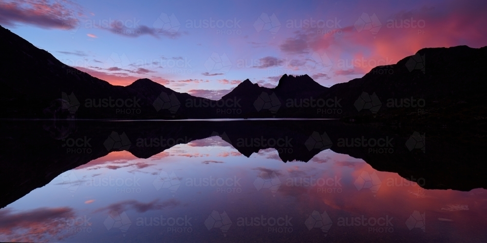 Cradle Mt reflected in Waters  of Dove Lake at dawn - Australian Stock Image