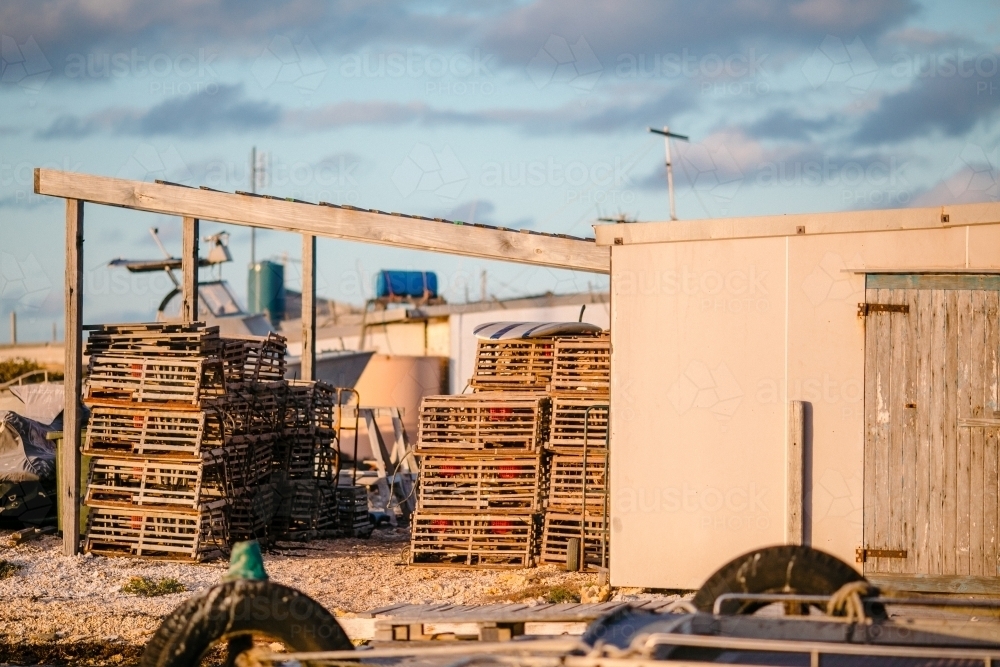 Craypots and fishing shacks in the late afternoon light - Australian Stock Image