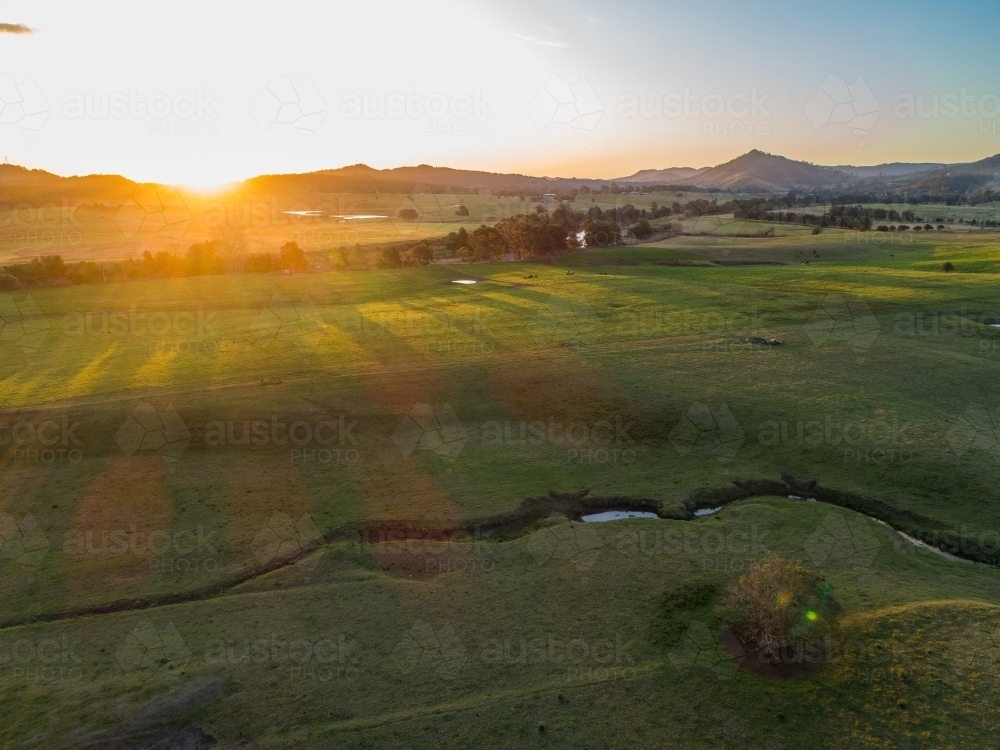 Creek winding through green Australian farm landscape  - Australian Stock Image