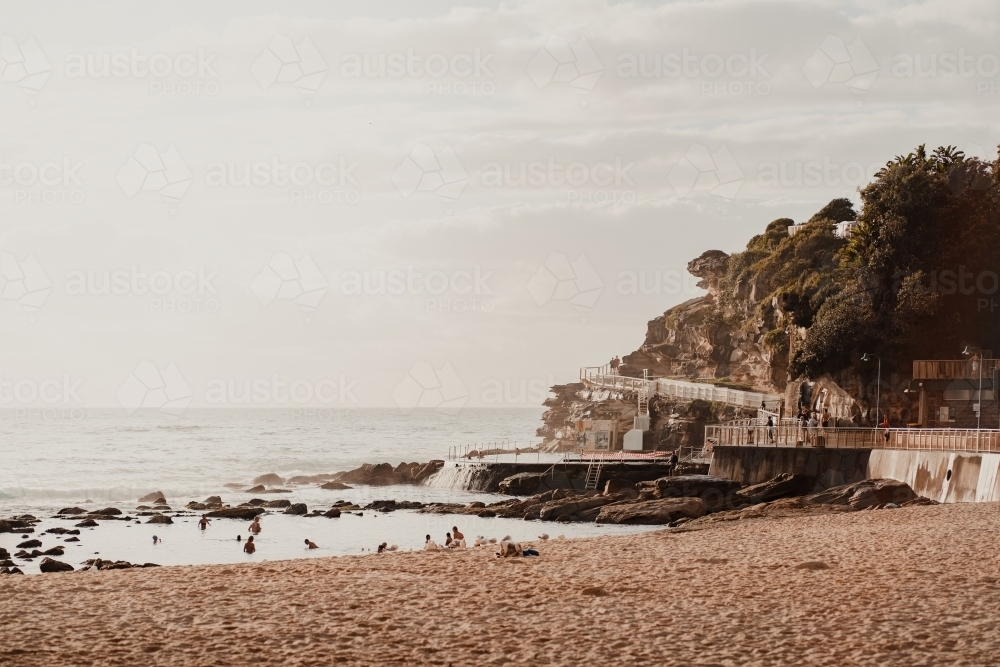 crowd of people swimming at the Bogey Hole and Bronte Ocean Pool (Bronte Baths) at sunrise - Australian Stock Image