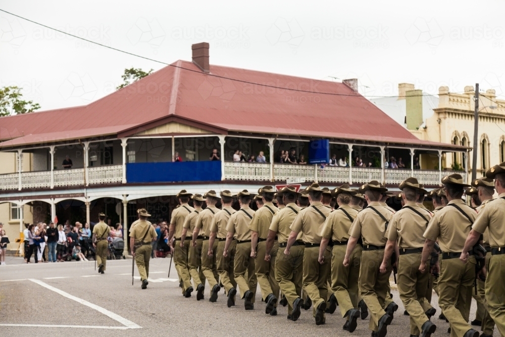 Crowds come out to watch army soldiers marching down main street on ANZAC Day parade - Australian Stock Image