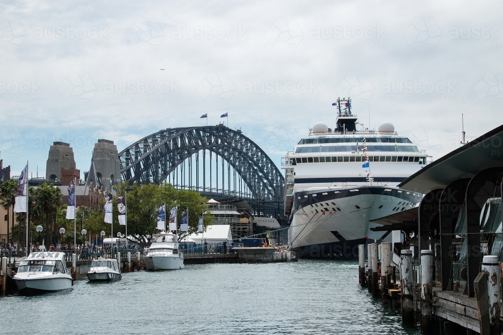 Cruise ship docked in Sydney Harbour with bridge behind - Australian Stock Image