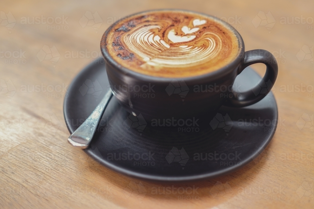 Cup of coffee cappuccino art - Australian Stock Image