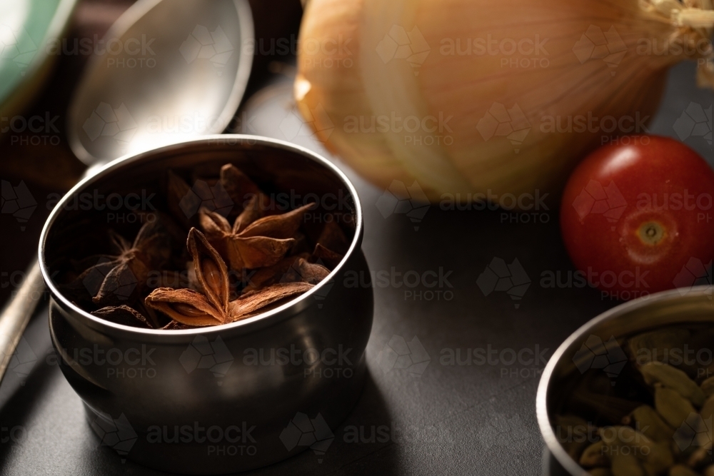 Curry ingredients with tin of star anise - Australian Stock Image