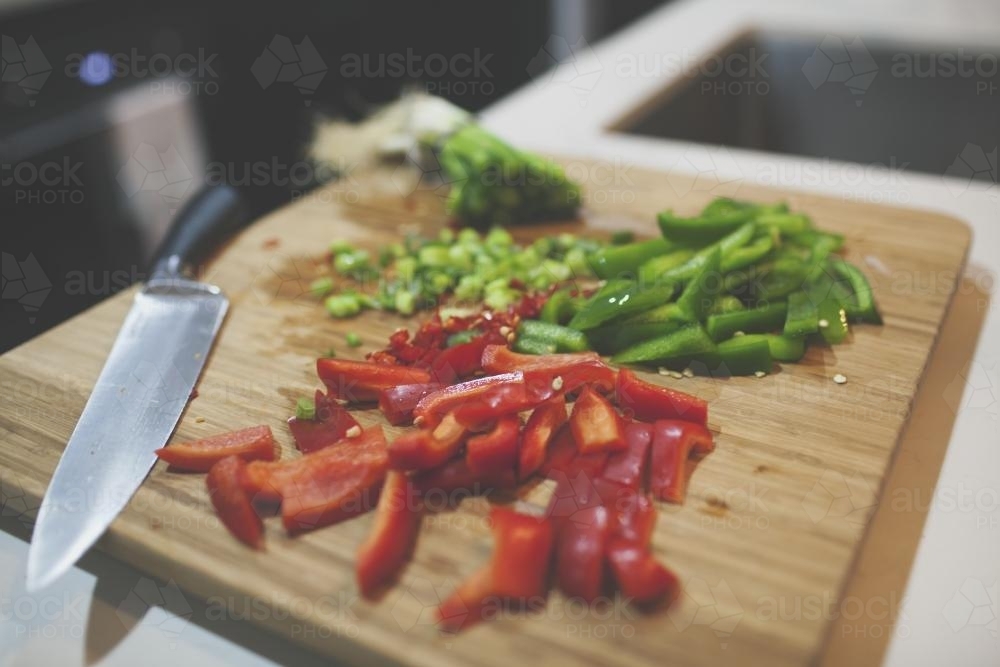 Cut capsicum on a cutting board - Australian Stock Image