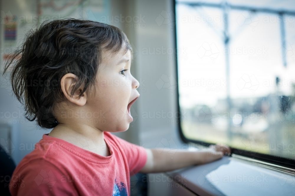 Cute 2 year old boy travels on a Sydney train - Australian Stock Image