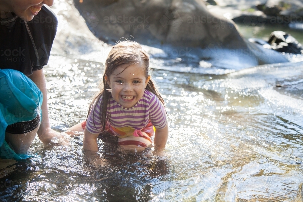 Cute little girl splashing in water at Ladies Well - Australian Stock Image