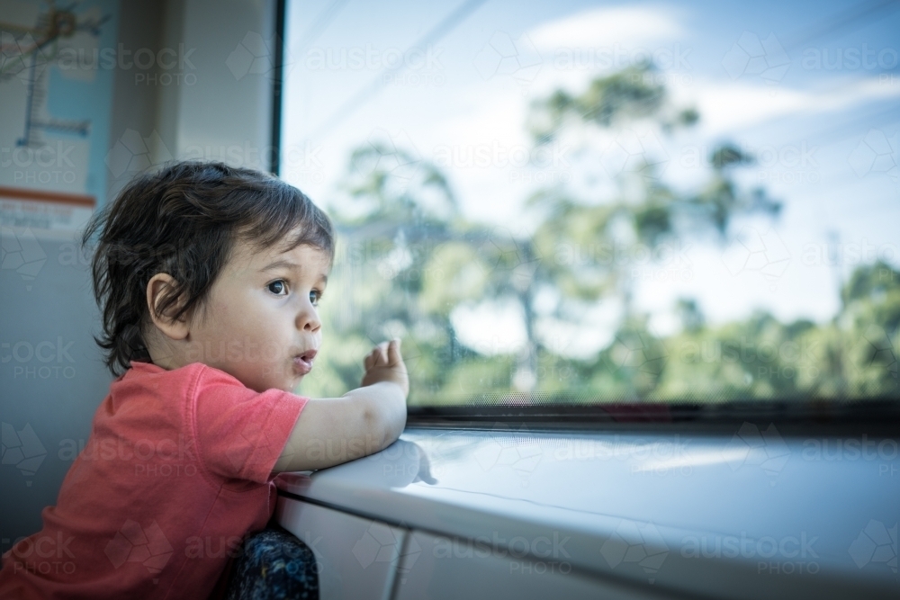 Cute two year old boy travels on a Sydney train - Australian Stock Image