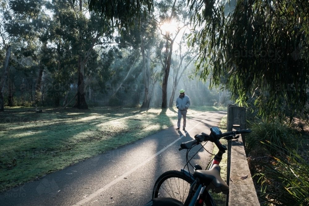 Cyclist Walking Towards His Bike on a Bike Path - Australian Stock Image