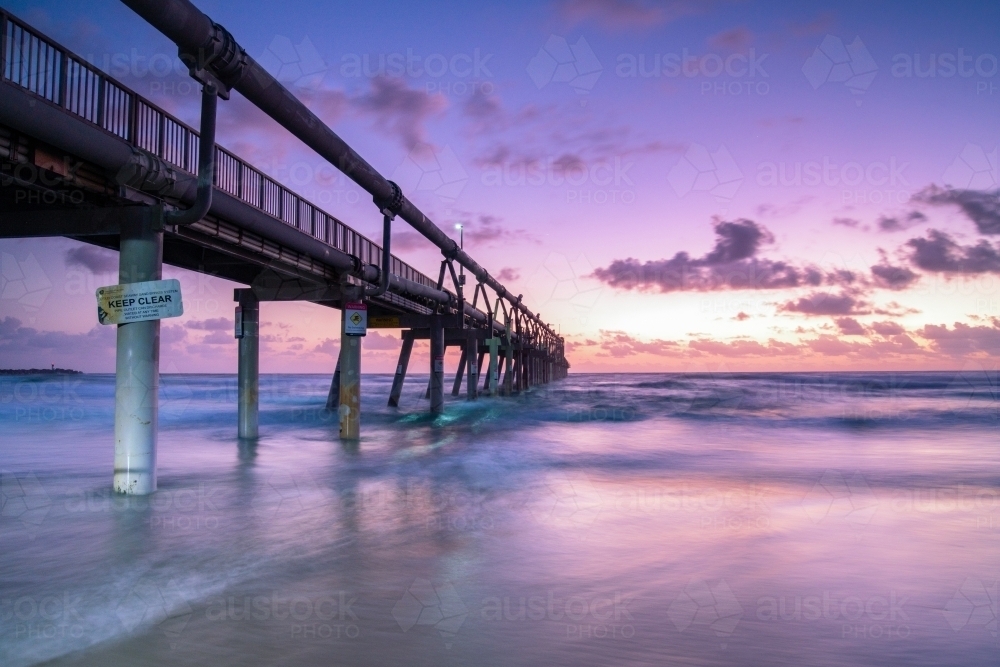 Dawn at the Spit, Gold Coast looking out to the pier with long exposure. - Australian Stock Image