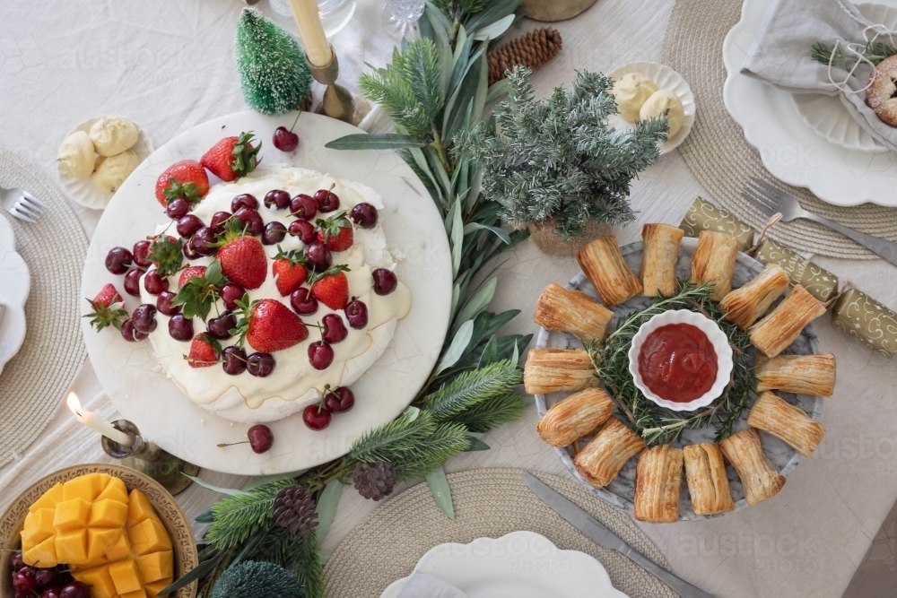 Decorated Christmas table with pavlova and pastries - Australian Stock Image