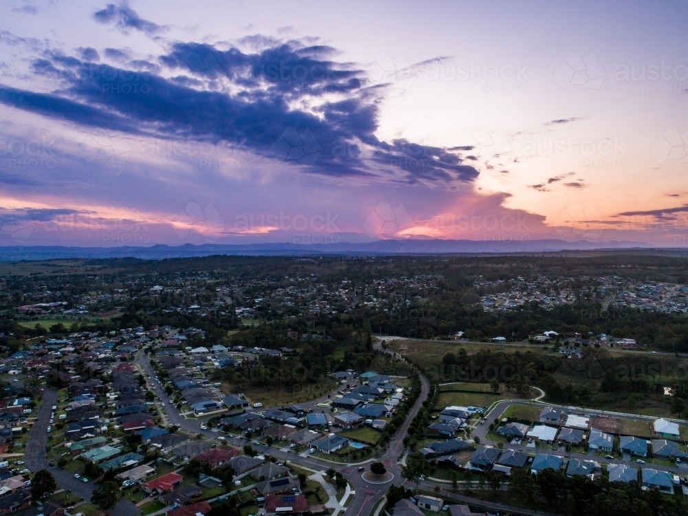 Deep purple sunset sky over houses of Singleton in NSW Australia - Australian Stock Image