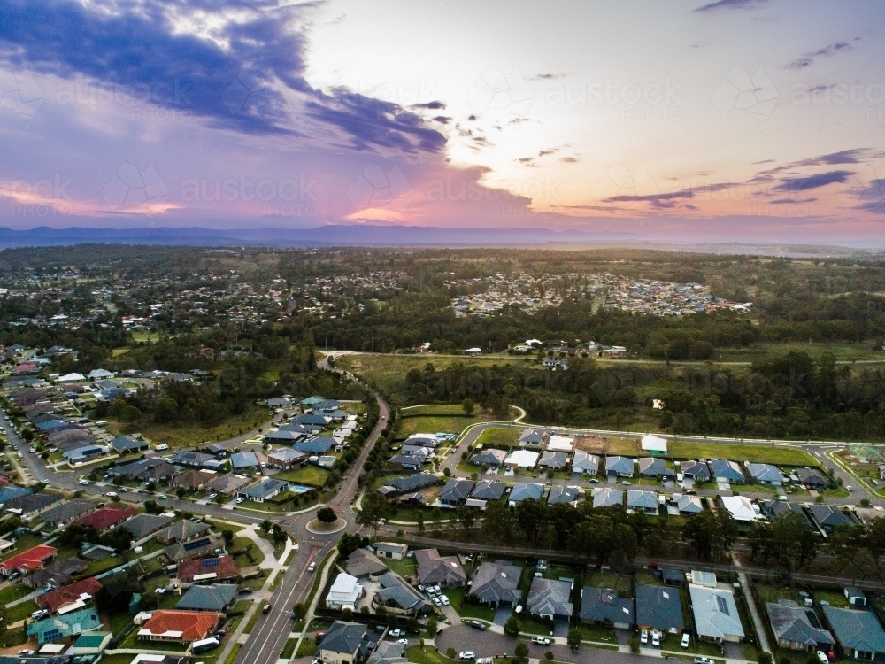 Deep purple sunset sky over houses of Singleton in NSW Australia - Australian Stock Image