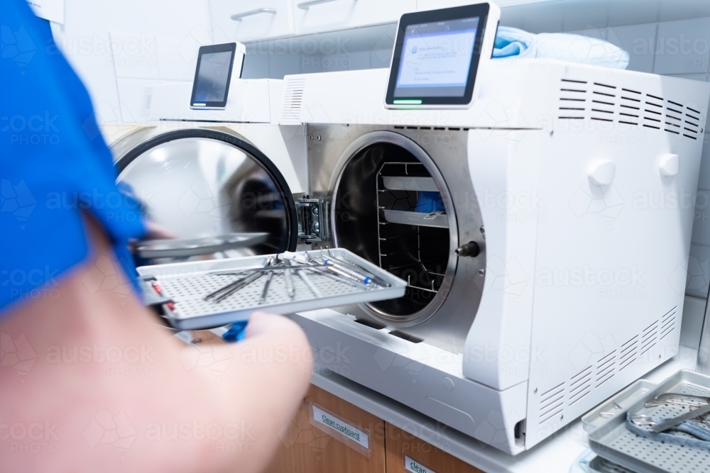 Dental instruments going into autoclave to be sterilised - Australian Stock Image