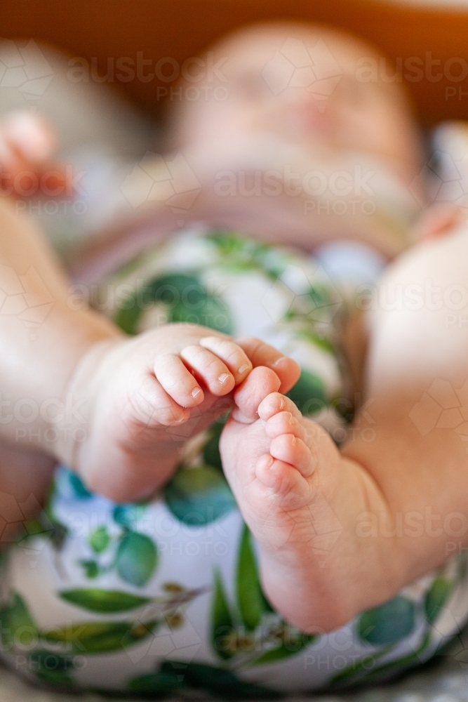 Detail of baby toes and modern cloth nappy - eco friendly lifestyle - Australian Stock Image