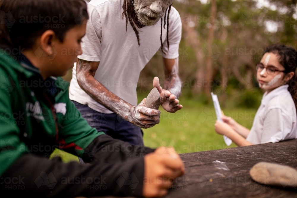 dharawal man explaining how sacred rocks were used by previous generations - Australian Stock Image