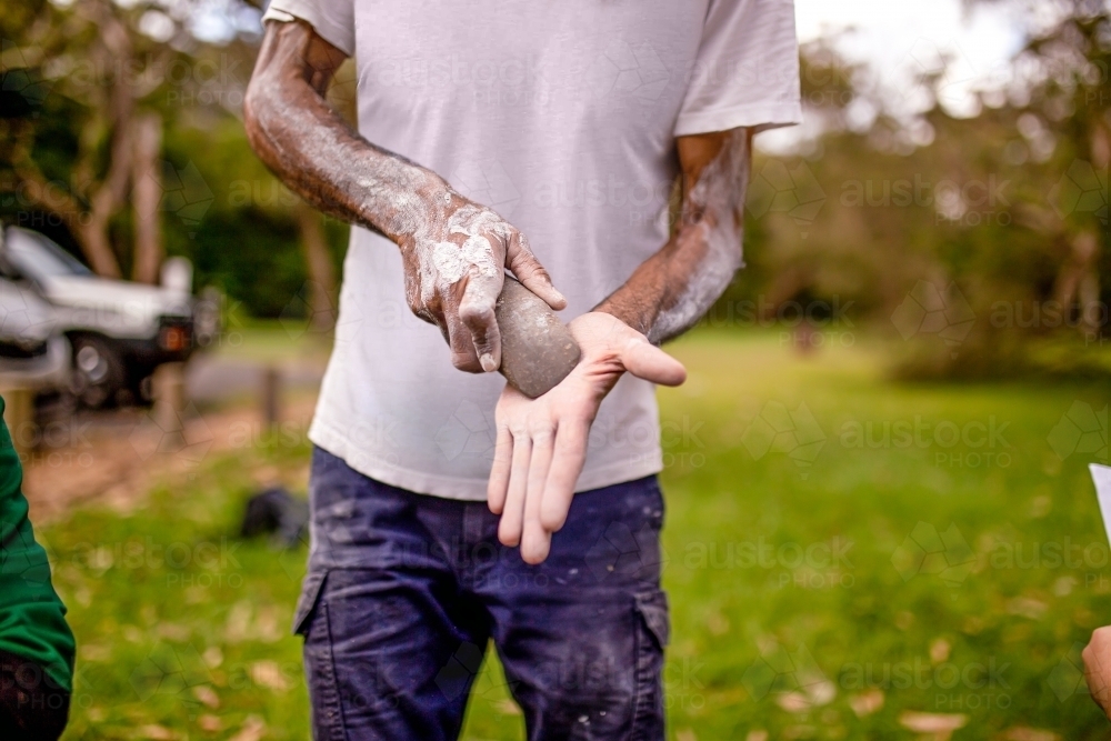 dharawal man explaining how sacred rocks were used by previous generations - Australian Stock Image