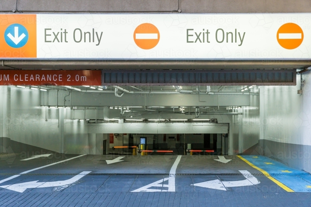 Directional signs at the opening of an underground carpark. - Australian Stock Image