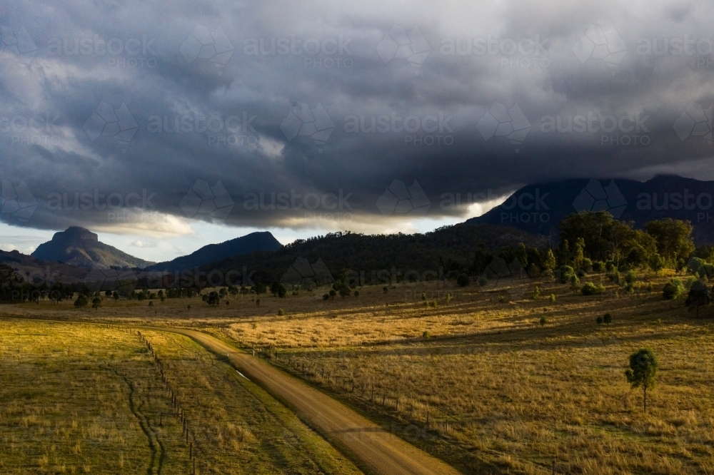 dirt road in front of mountains - Australian Stock Image