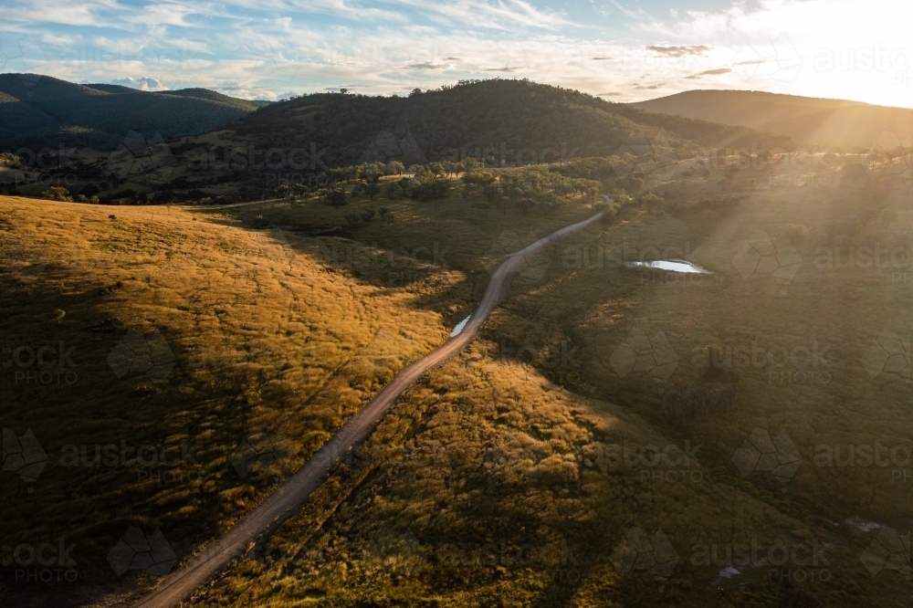 dirt road through granite belt landscape - Australian Stock Image