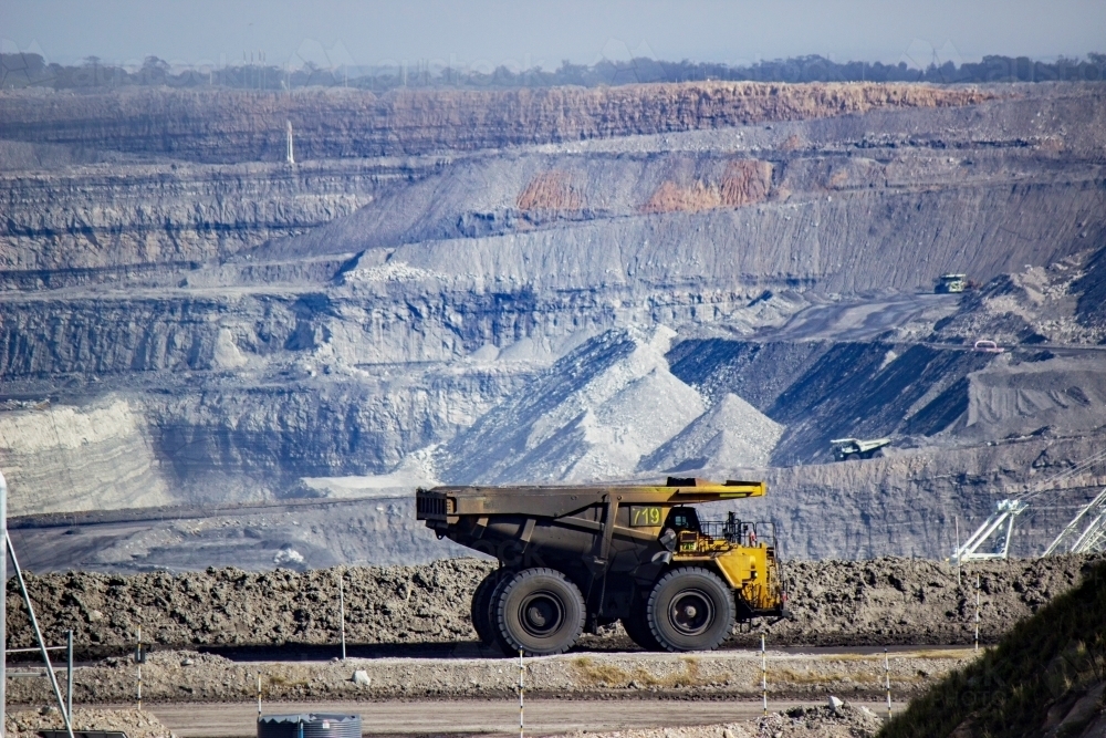 Dirty dump truck driving through open cut coal mine near singleton - Australian Stock Image