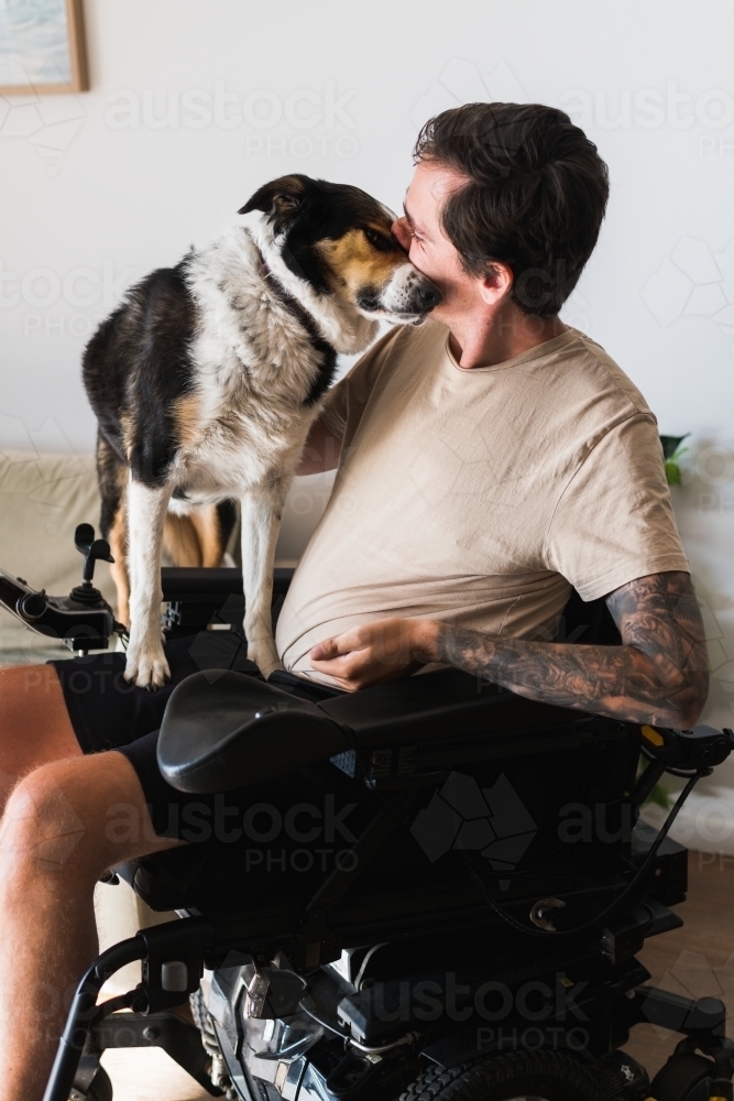 disabled man with his dog at home - Australian Stock Image