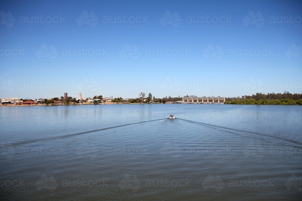 Distant view of boat on lake mulwala - Australian Stock Image