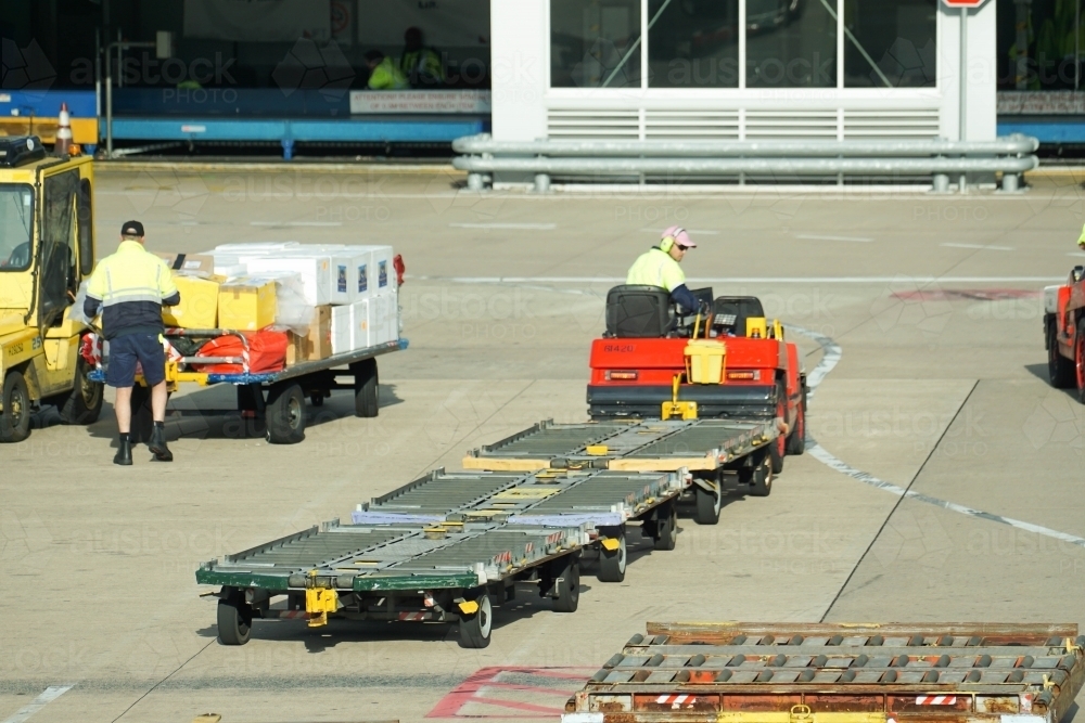 Driver with airport baggage cart - Australian Stock Image