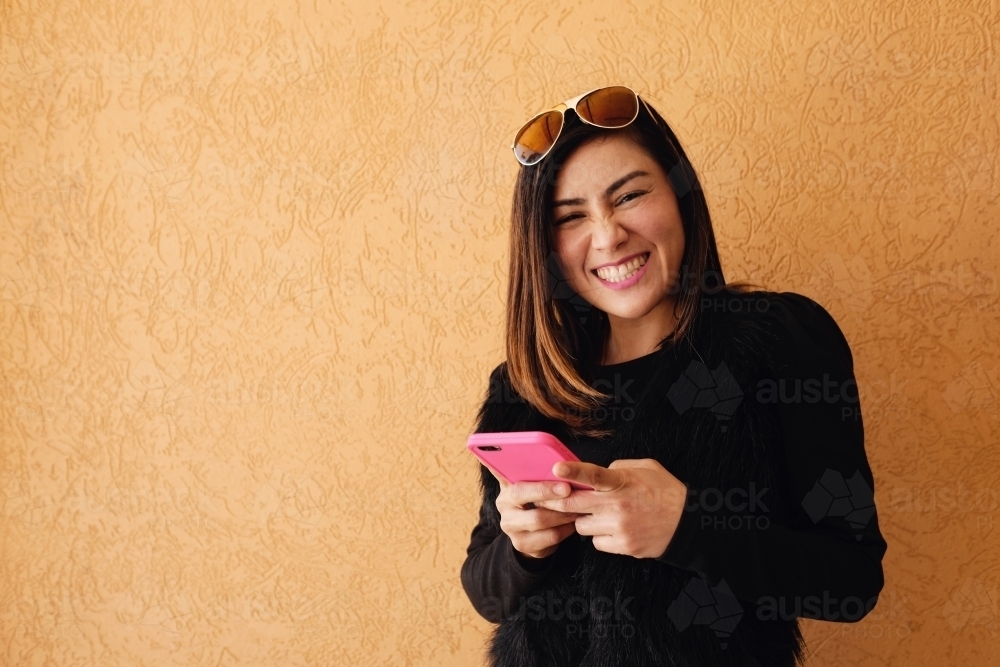 Southeast Asian multicultural woman using mobile phone - Australian Stock Image