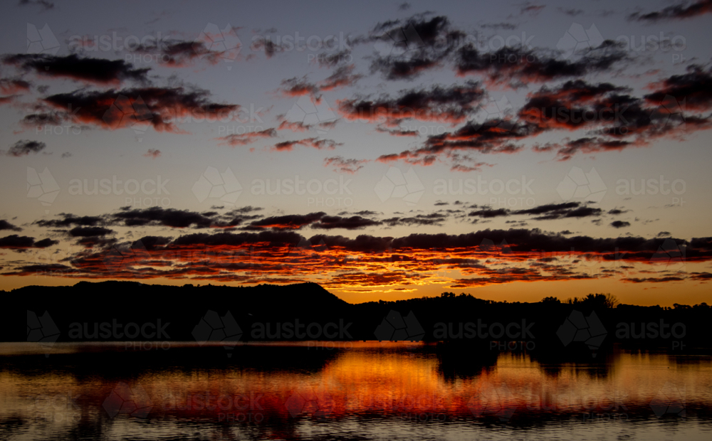 Dusk skies reflected in dam water - Australian Stock Image