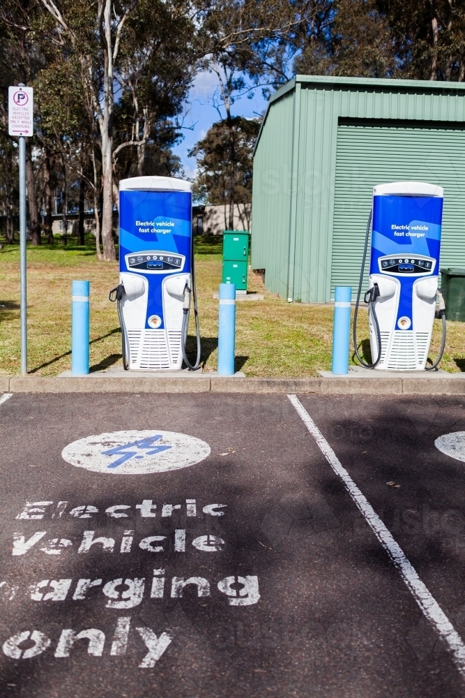 Electric vehicle charging only sign in carpark EV power plug station - Australian Stock Image