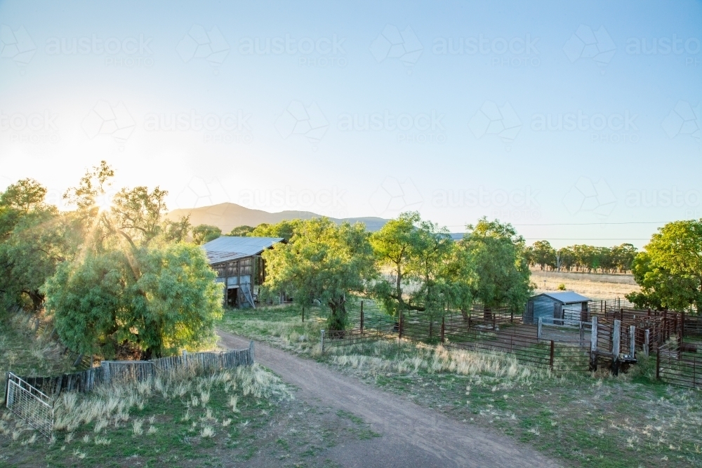 Elevated view of the sun rising over a farm landscape - Australian Stock Image