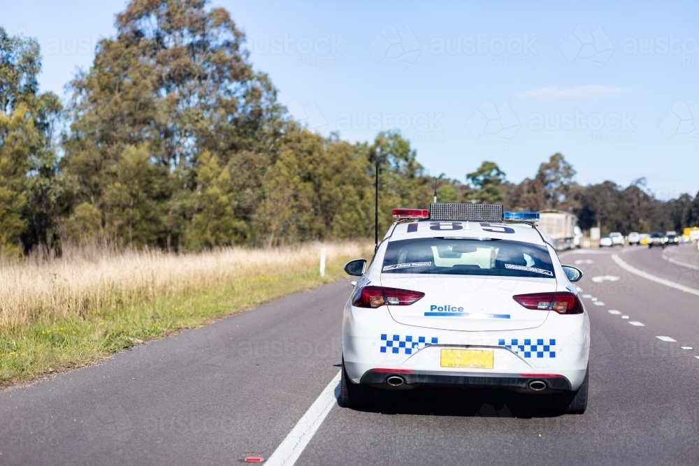 Emergency services traffic patrol police car driving down highway - Australian Stock Image