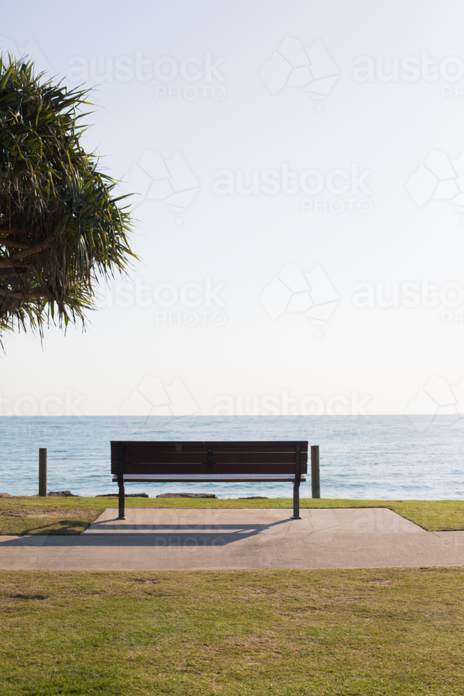 Empty Bench Overlooking Tranquil Beach View - Australian Stock Image