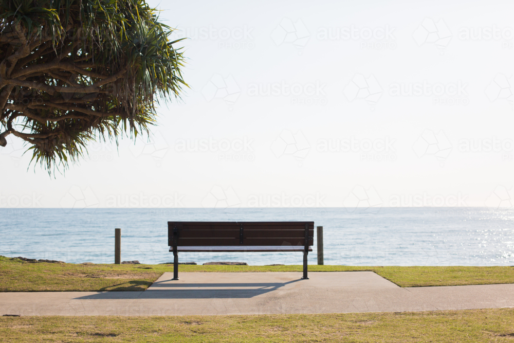 Empty Bench Overlooking Tranquil Beach View - Australian Stock Image