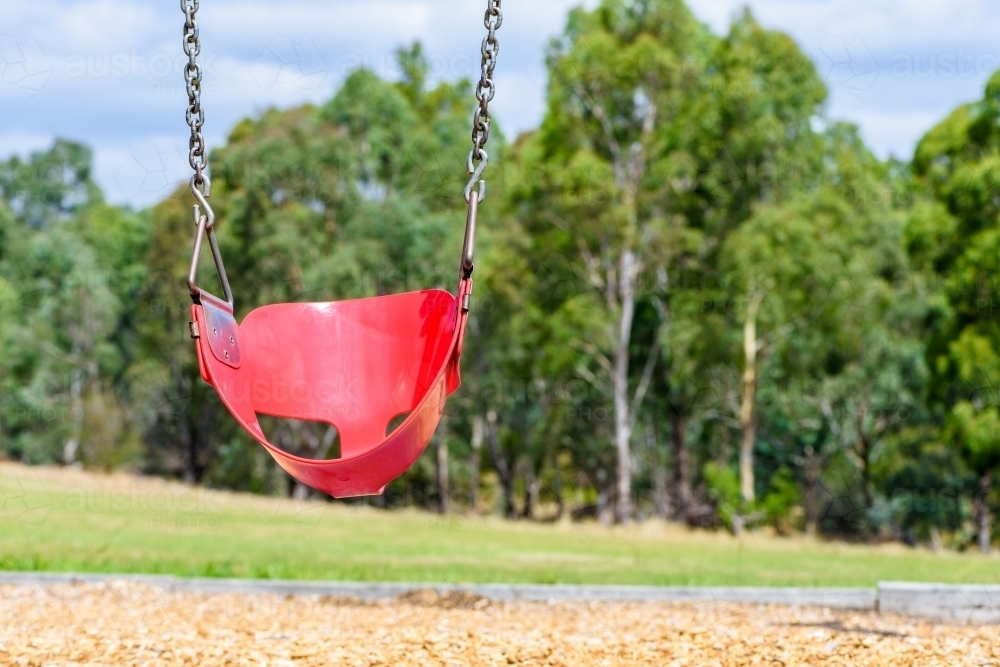 Empty chain swing in the playground in park - Australian Stock Image