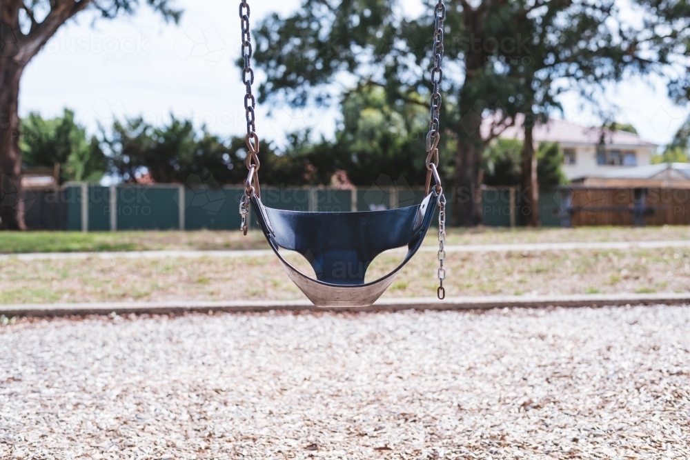 Empty chain swing in the playground in park - Australian Stock Image