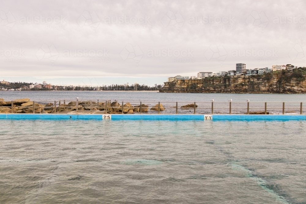 Empty ocean pool with urban and suburban background - Australian Stock Image