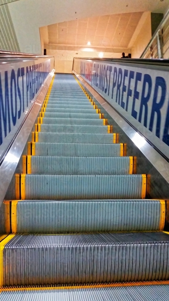 Escalator going up at an international airport - Australian Stock Image