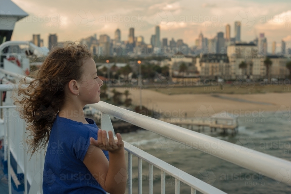 Excited young girl on ferry boat Port Melbourne with hair blowing in wind - Australian Stock Image