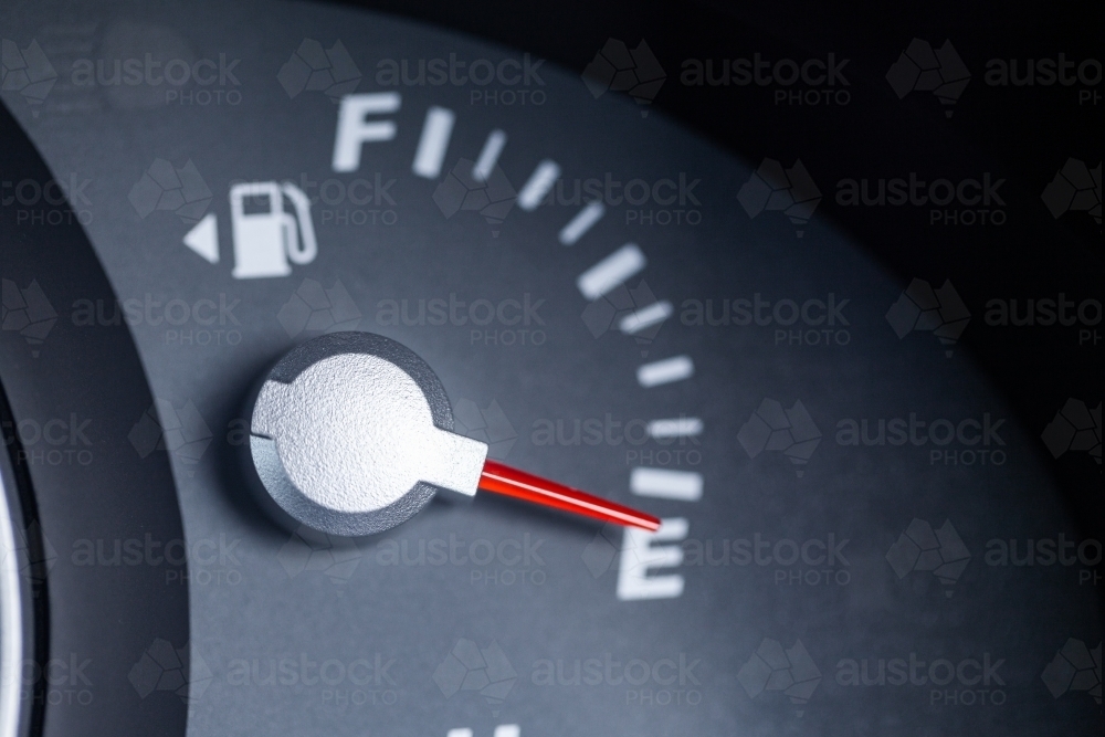 Expensive petrol concept rising cost of living - petrol gauge indicator on empty - Australian Stock Image