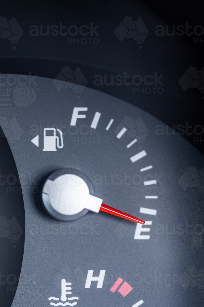 Expensive petrol concept rising cost of living - petrol gauge indicator on empty - Australian Stock Image