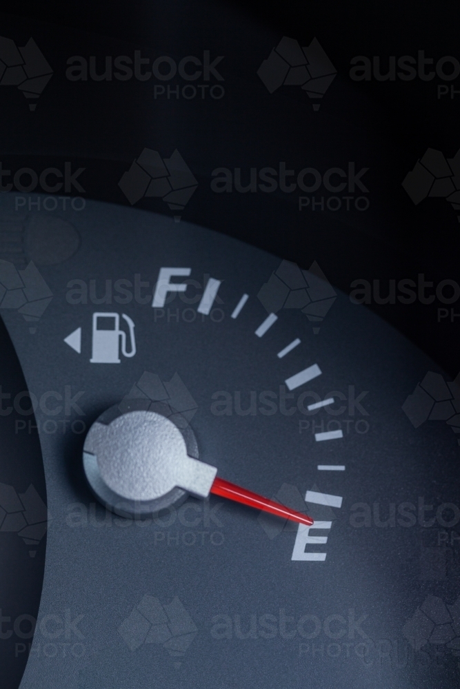 Expensive petrol concept rising cost of living - petrol gauge indicator on empty - Australian Stock Image