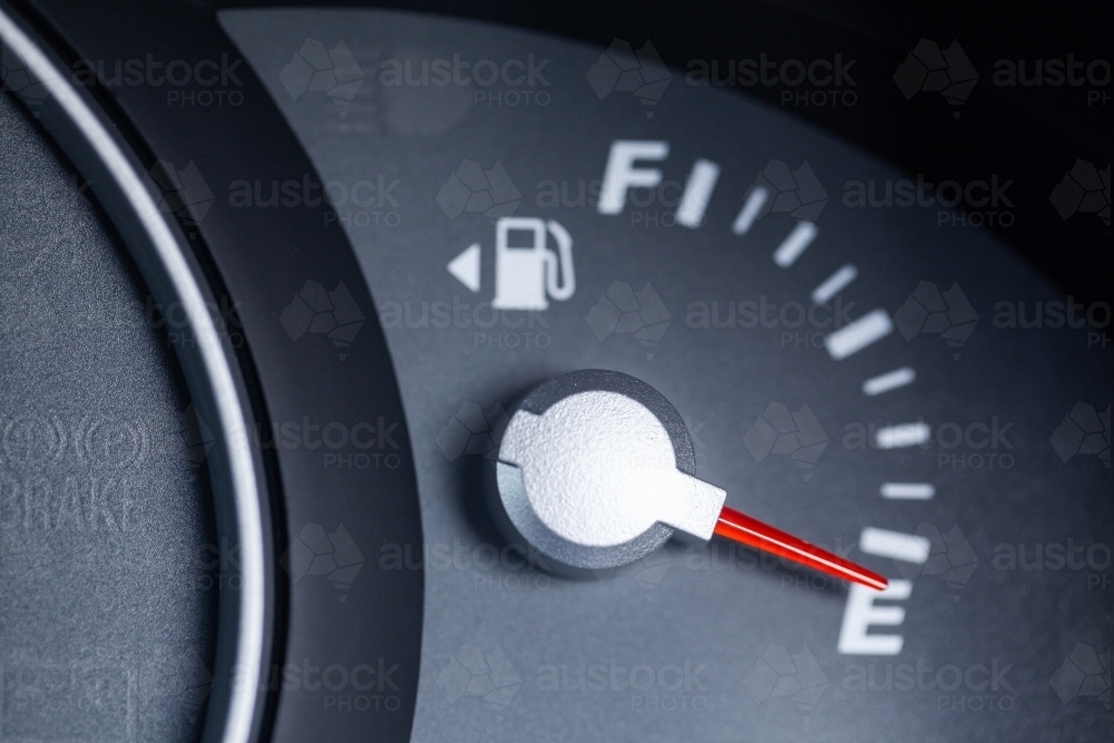 Expensive petrol concept rising cost of living - petrol gauge indicator on empty - Australian Stock Image