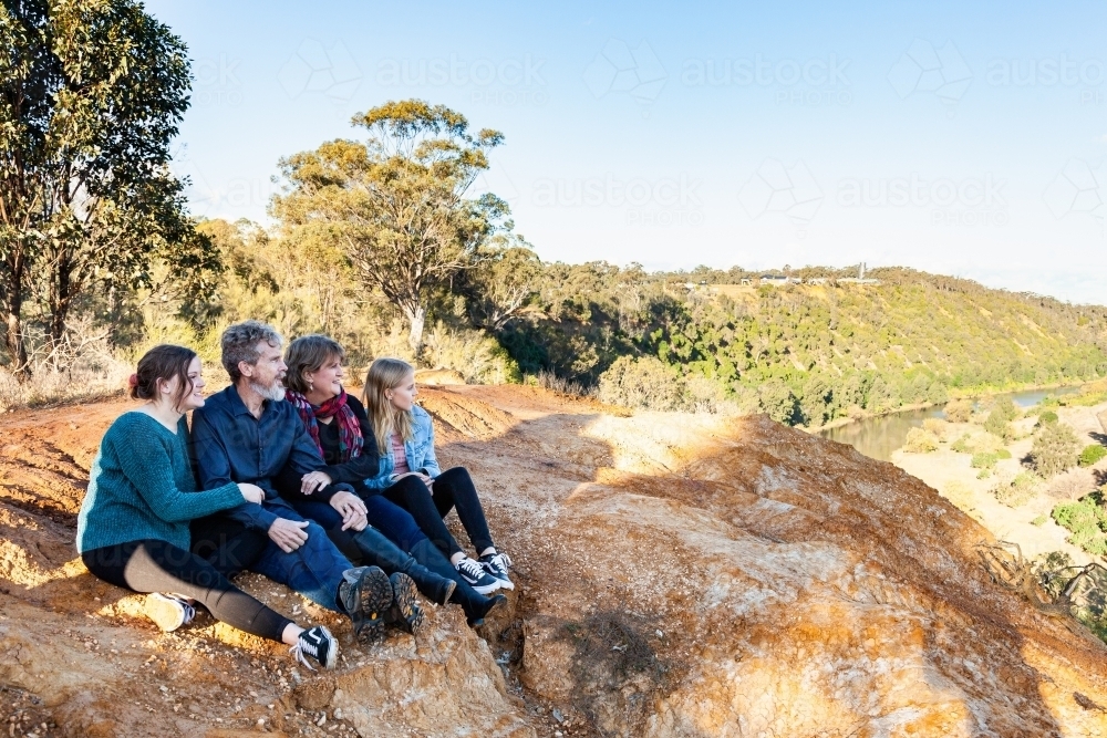 family looking out at view off cliff edge - Australian Stock Image