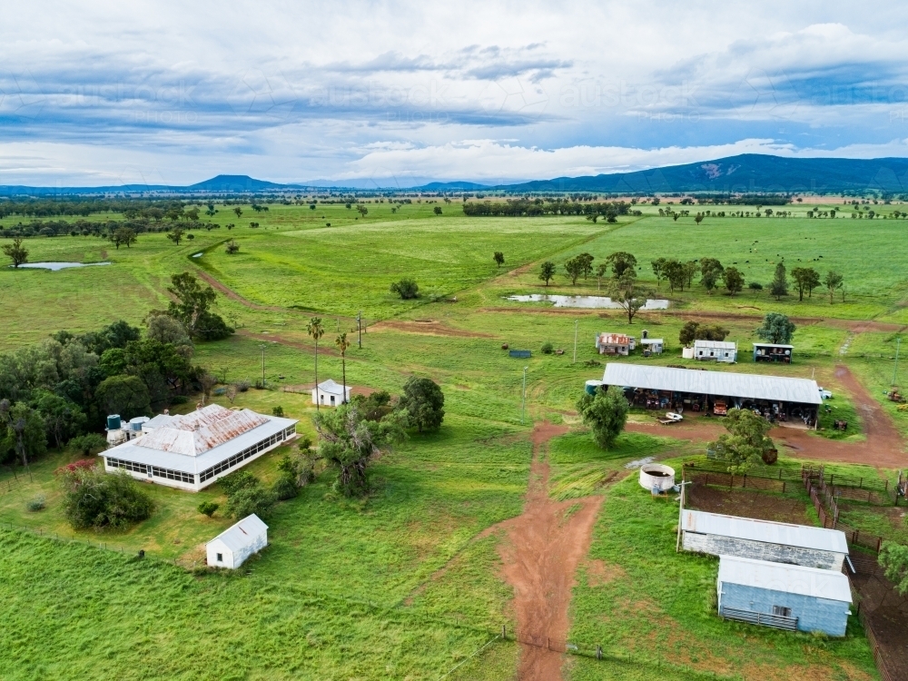 Farm buildings and stockyard seen from above on overcast day - Australian Stock Image