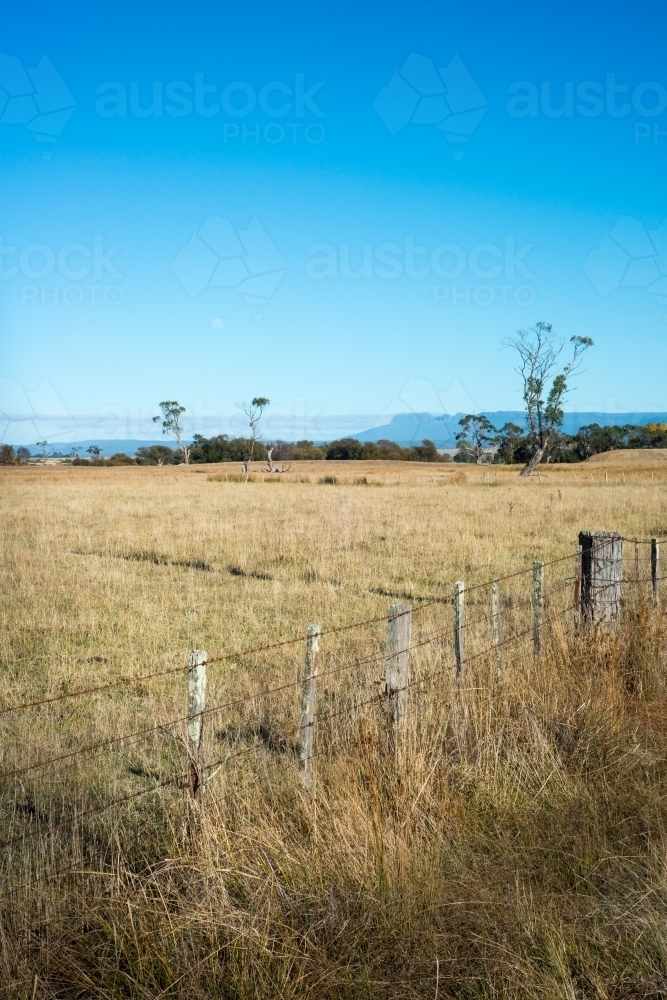 Farm paddock fence with mountains in background - Australian Stock Image