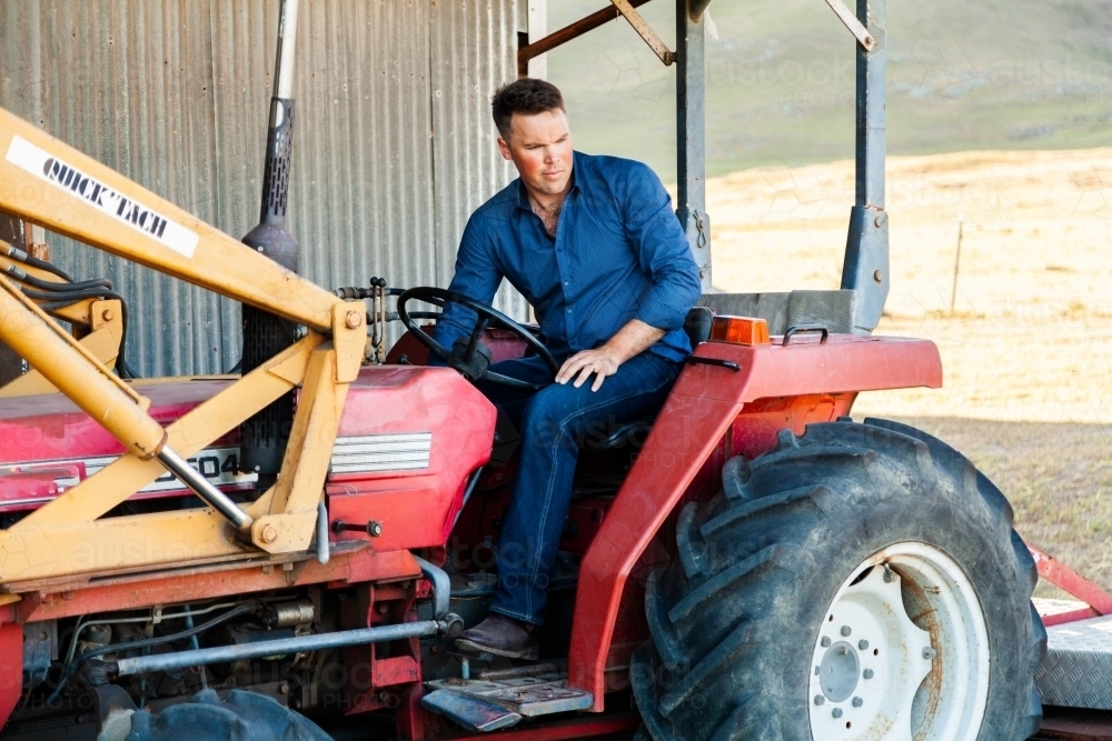 Farmer in tractor forklift on farm - Australian Stock Image